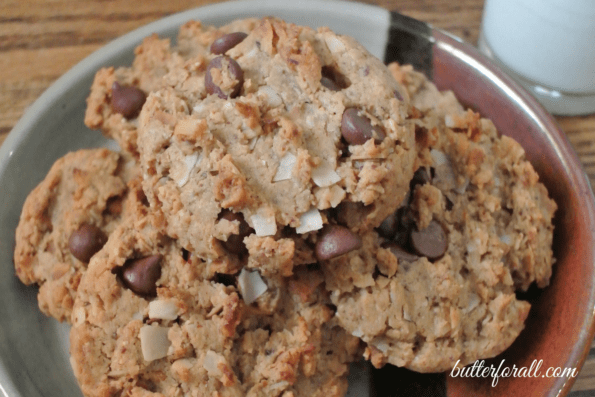 Several almond coconut chocolate chip cookies in a bowl.