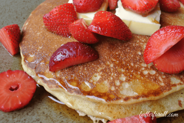 Sourdough pancakes with fresh strawberries on top.