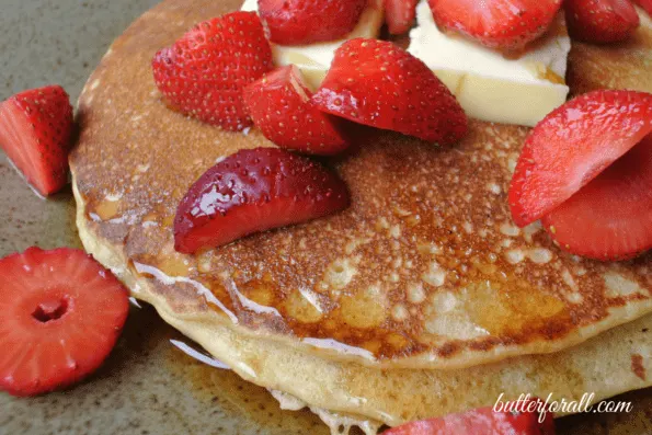 Sourdough pancakes with fresh strawberries on top.