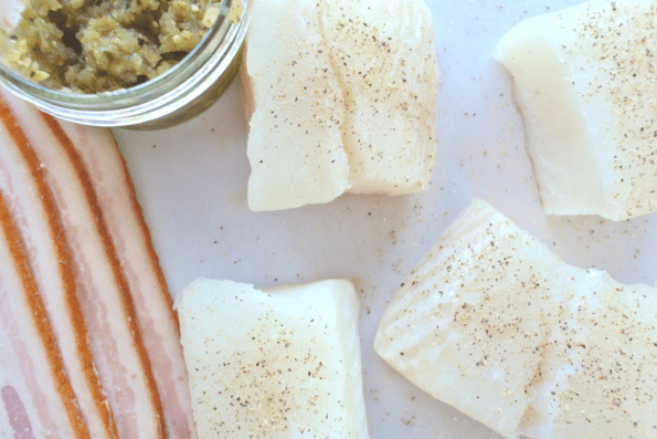 Pieces of fresh halibut and raw bacon.