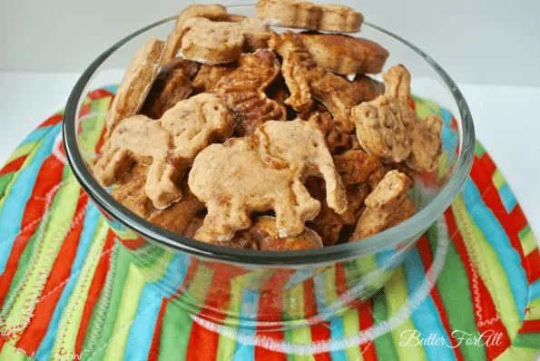 A glass bowl of baked cinnamon date animal cookies.