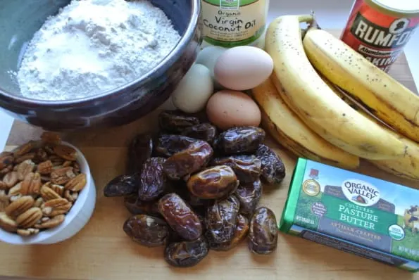 Ingredients to bake banana date bread displayed on a cutting board.