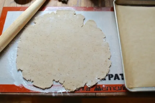 Cookie dough rolled out on a cutting board.