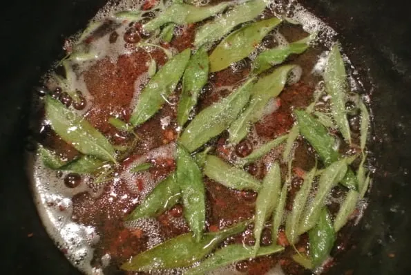 Sage leaves cooking in pork drippings.