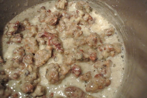 Sausage and flour roux cooking in a pot.