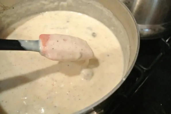 Thick gravy in a bowl with a spatula.