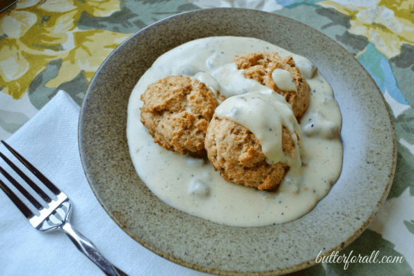Traditional biscuits and sausage gravy on a plate.