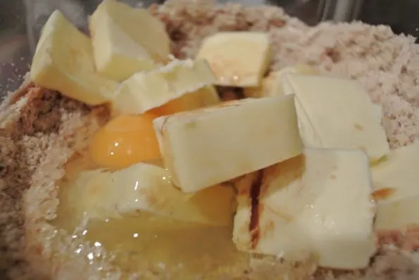 Butter and egg added to a food processor.