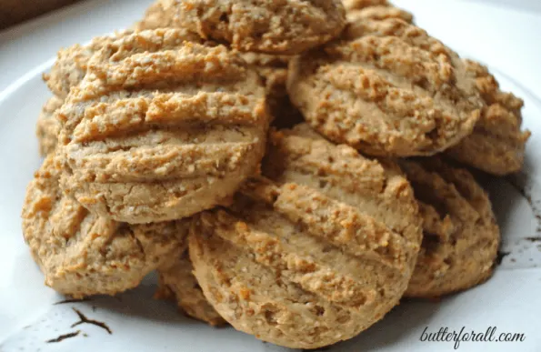 A pile of baked apricot cashew cookies on a plate.