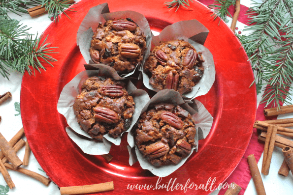 Four little fruit and nut cakes on a plate.