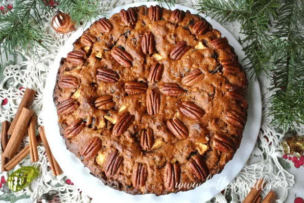 A beautiful big fruit cake studded with pecans.