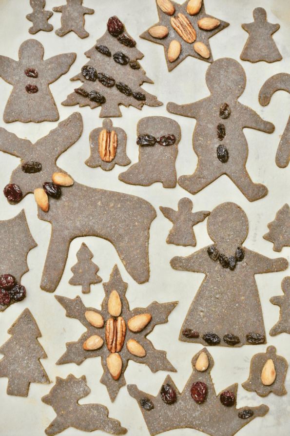 Decorated gingerbread cut-out cookies with fruit and nuts.