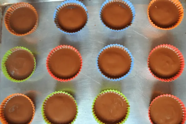 Baking cups with a final topping of chocolate.