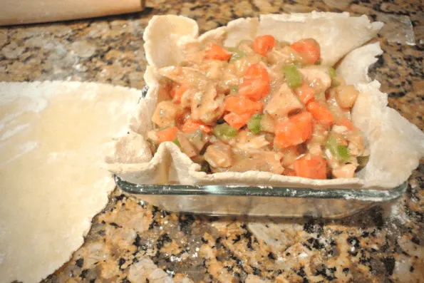 A pot pie crust filled with turkey and vegetables.