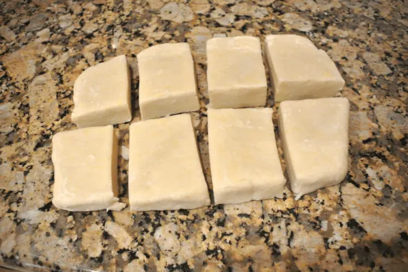 Pie dough cut into sections on the counter.