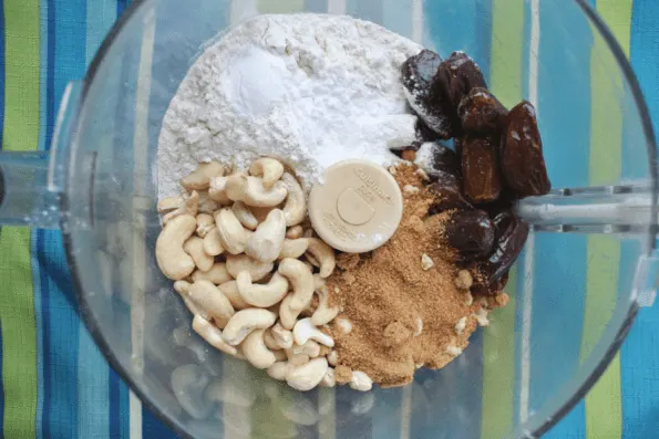 Flour, cashews, coconut sugar, and dates in a food processor.