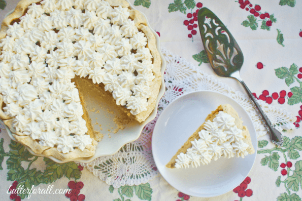 A large Winter Squash Pie decorated with piped whipped cream.