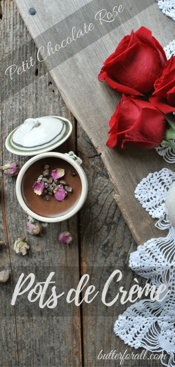 A petit chocolate rose pot de crème on a wooden table with red roses and a text overlay.