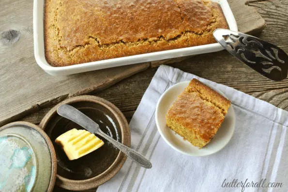 A pan and a plate of clabber milk corncake with a dish of butter.