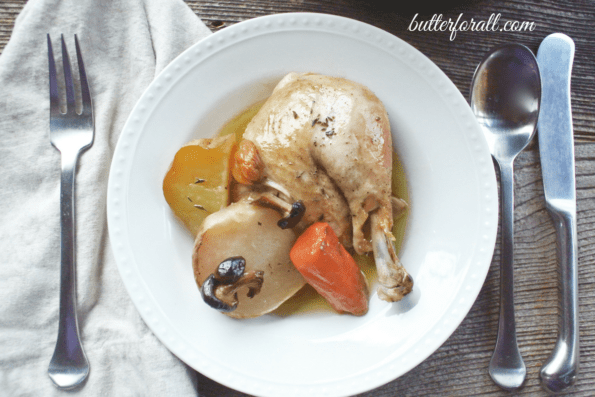 A plate of Dutch oven roasted chicken with seasonal vegetables.
