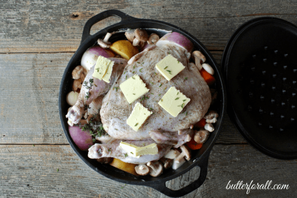 Dutch oven roasted chicken with seasonal vegetables in a pot ready to bake.