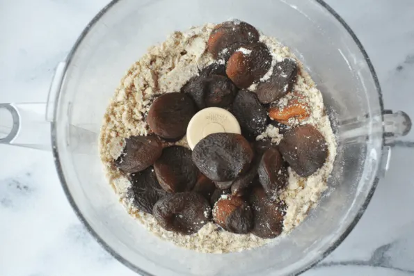 Dry ingredients plus apricots in a mixing bowl.