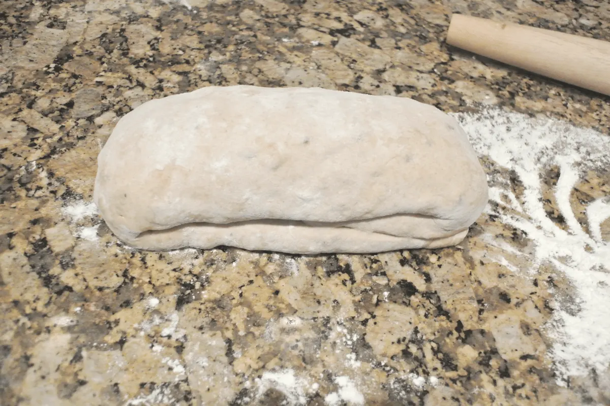 Cinnamon raisin sourdough loaf resting on the counter.