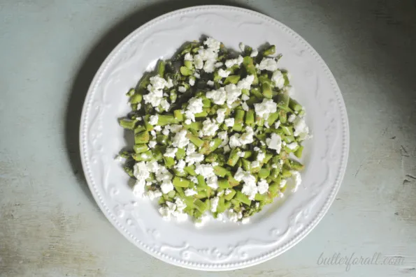 A plate of warm asparagus, habanero, and feta salad.