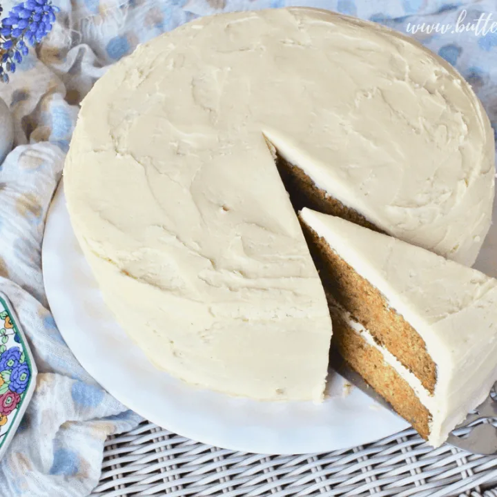 A perfect slice of double decker carrot cake loaded with cream cheese frosting.