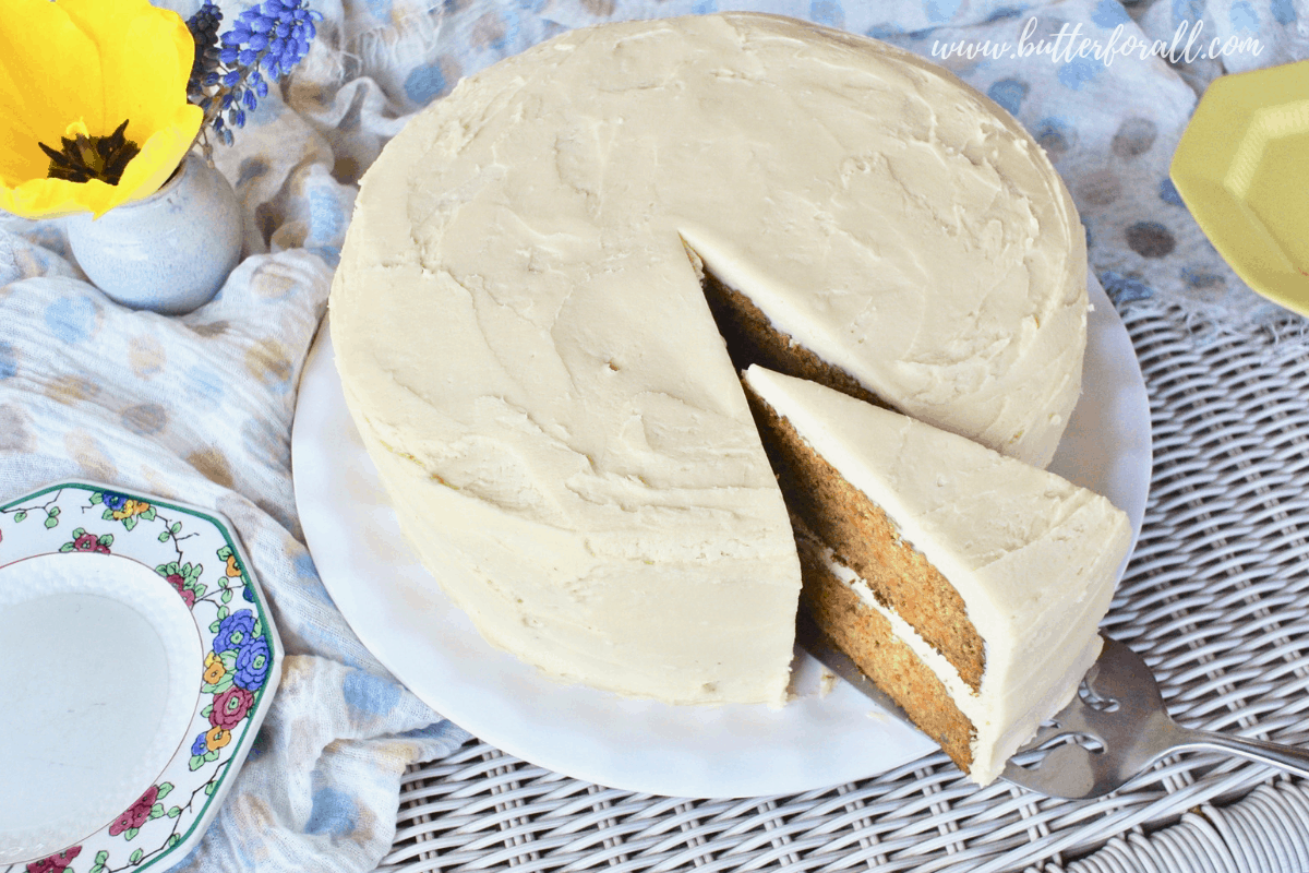 A perfect slice of double decker carrot cake loaded with cream cheese frosting.