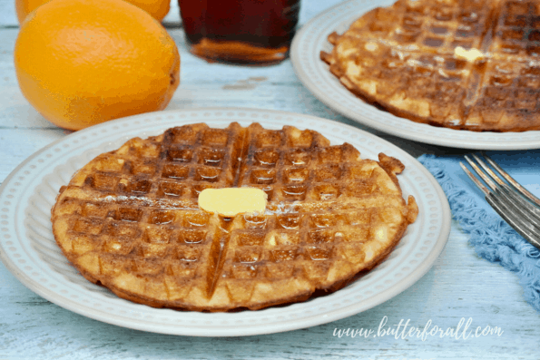 A sourdough waffle with maple syrup and butter.