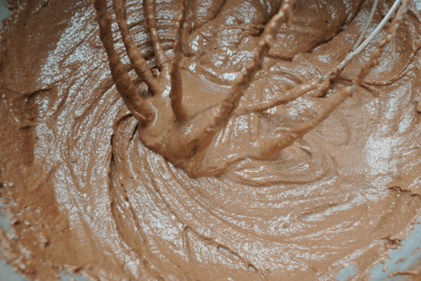 Coconut butter fudge batter in a bowl with a whisk.
