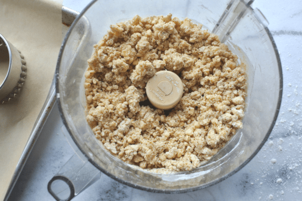 Ingredients being mixed in a food processor bowl.