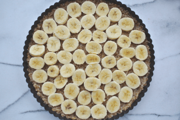The crust with a layer of banana slices.