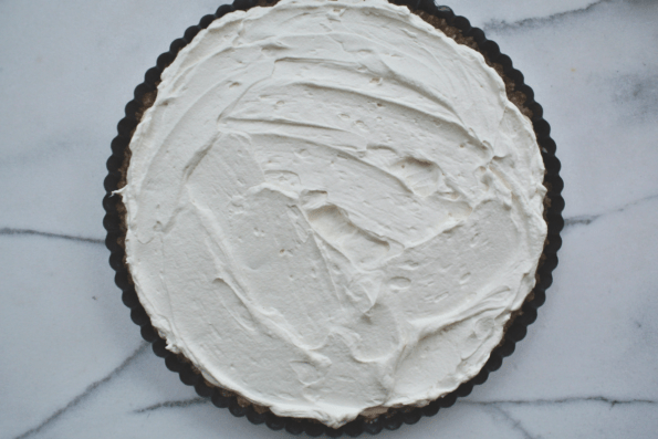 The crust with a layer of whipped cream.