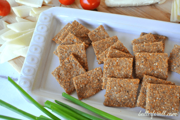 A plate of low-carb sesame, cheese, and nut crackers.