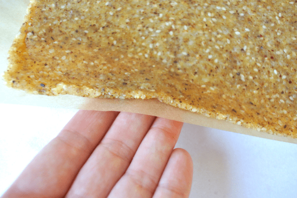 Sesame, cheese, and nut cracker dough rolled out, showing the correct thickness.