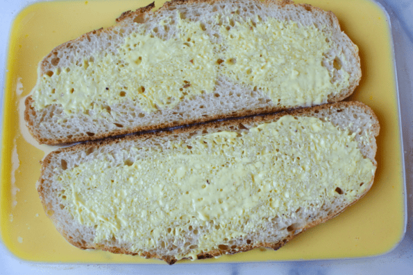 Slices of sourdough soaking in egg batter.