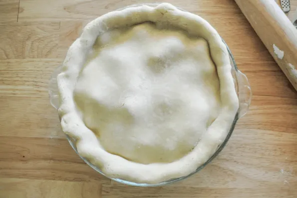 The unbaked crust ready for crimping.