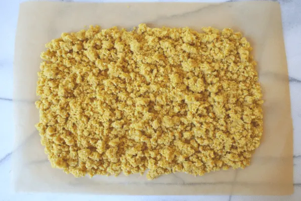 Cracker dough spread onto parchment.