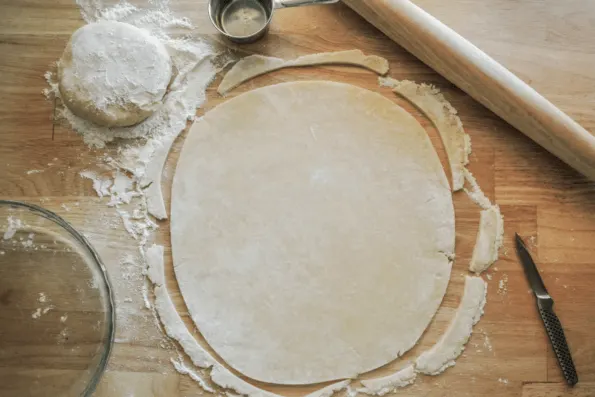 Rolled pie dough with trimmed edges.