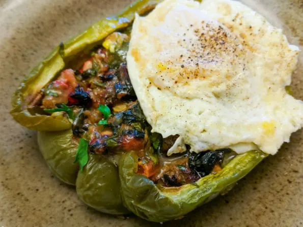 A leftover stuffed bell pepper with a fried egg on top.