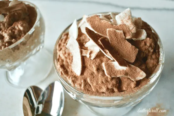 A close-up of a bowl of chocolate coconut and almond chia seed pudding.