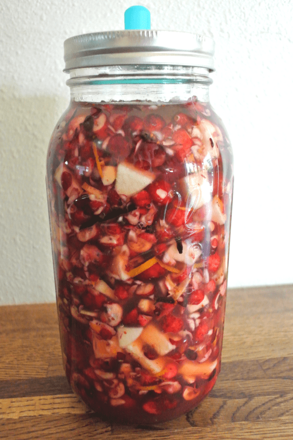 A jar of cranberries fermenting.