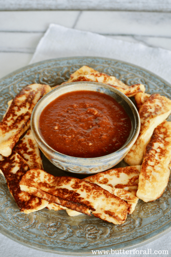 Grain-free butter-fried bread cheese sticks on a plate with marinara sauce.