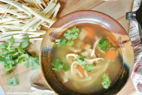 A bowl of grain-free chicken noodle soup with noodles made from bread cheese.