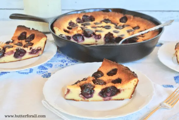A pan and two plates of clafoutis made with tummy-friendly, naturally fermented, and leavened sourdough starter.