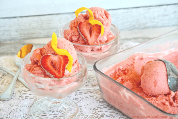 A tray and two glass dishes of strawberry sherbert.