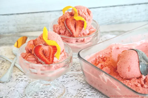 A tray and two glass dishes of strawberry sherbert.