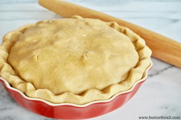 An unbaked pie in a pie dish.